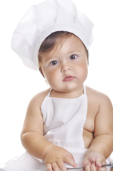 Divertido adorable bebé chef sentado y jugando con el equipo de cocina — Foto de Stock