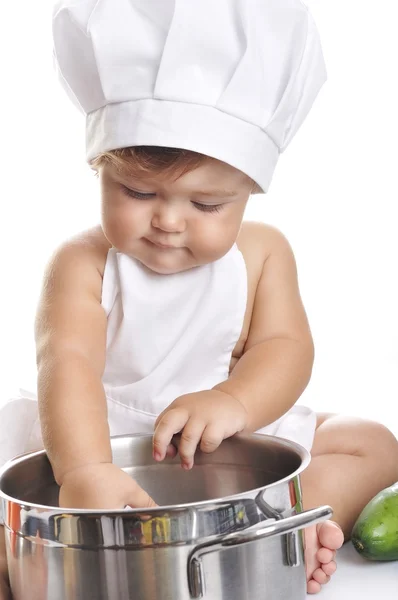 Funny adorable baby boy chef sitting and playing with kitchen equipment — ストック写真