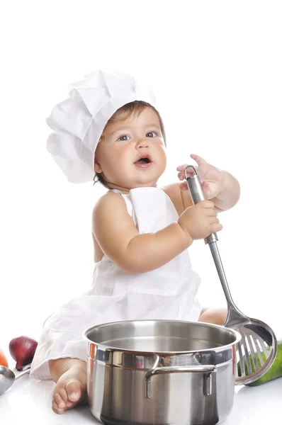 Funny adorable baby boy chef sitting and playing with kitchen equipment — Stok fotoğraf