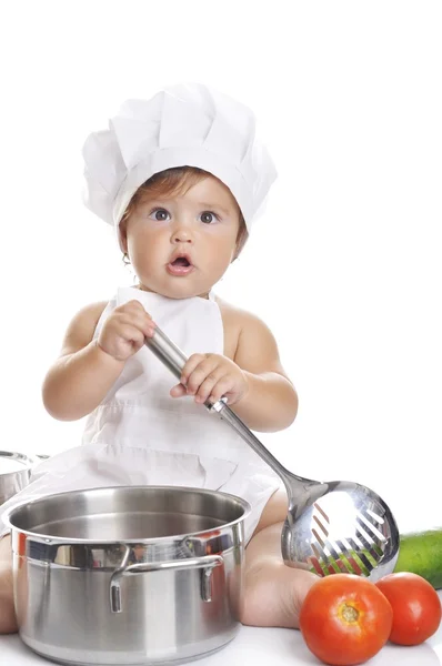 Funny adorable baby boy chef sitting and playing with kitchen equipment — ストック写真