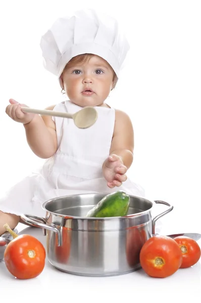 Funny adorable baby boy chef sitting and playing with kitchen equipment — ストック写真