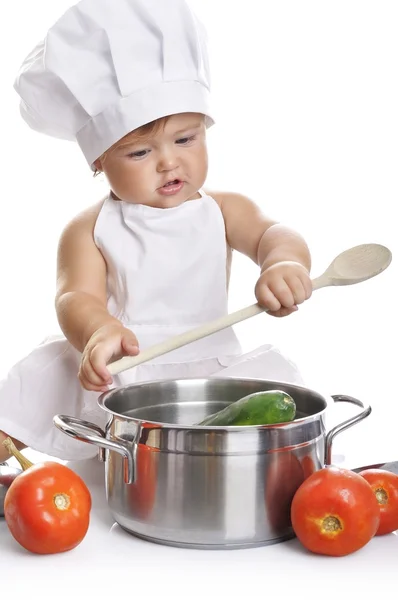 Funny adorable baby boy chef sitting and playing with kitchen equipment — ストック写真