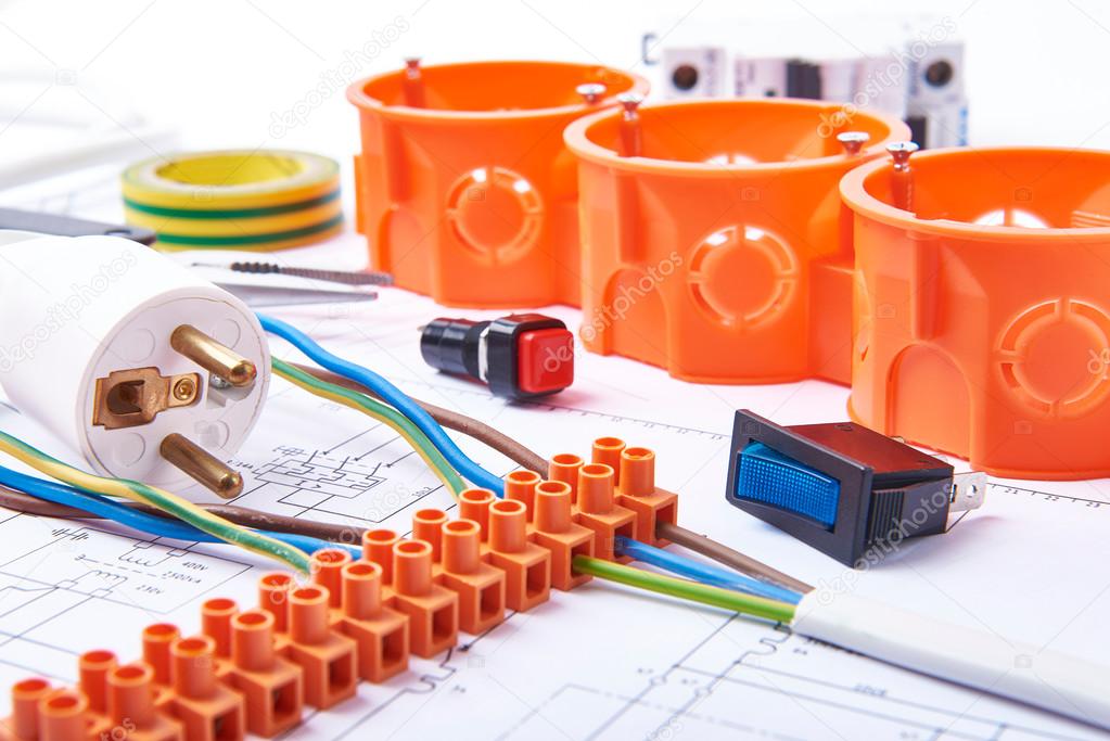 Components for use in electrical installations. Plug, connectors, junction box, switch, isolation tape and wires. Accessories for engineering work, energy concept.