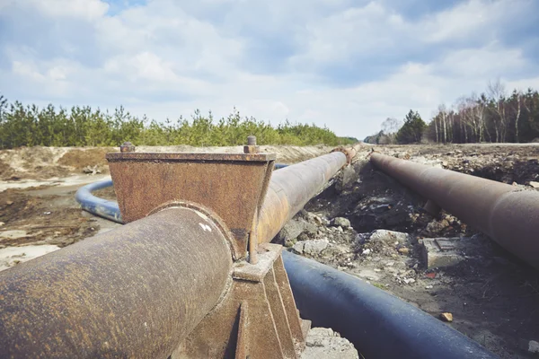 Steal big pipeline on a ground. Old pipes joint.