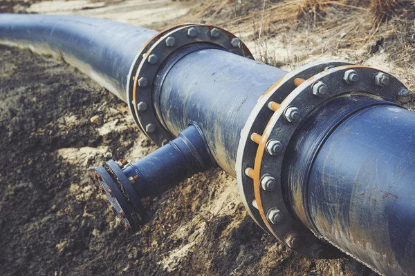 Steal big pipeline on a ground. Old pipes joint. — Stock Photo, Image
