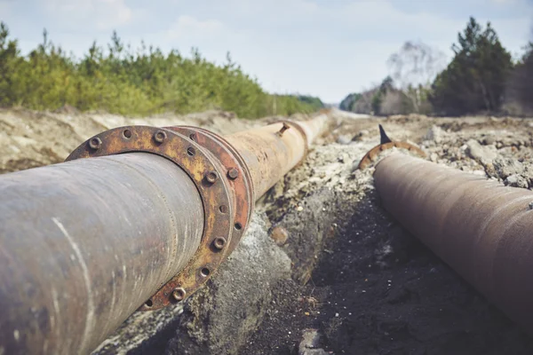 Steal big pipeline on a ground. Old pipes joint. — Stock Photo, Image