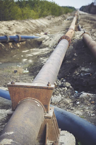 Steal big pipeline on a ground. Old pipes joint. — Stock Photo, Image