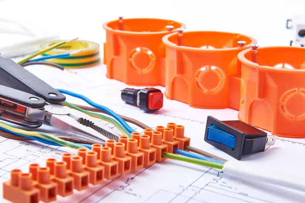 Components for use in electrical installations. Connectors, junction box, switch, isolation tape and wires. Accessories for engineering work, energy concept. — Stock Photo, Image