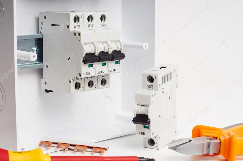 Fusebox with four automatic fuses during installation. Electricity