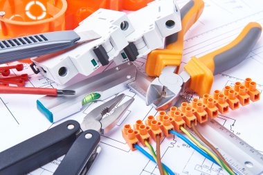 Components for use in electrical installations. Cut pliers, connectors, fuses, knife and wires. Accessories for engineering work, energy concept.