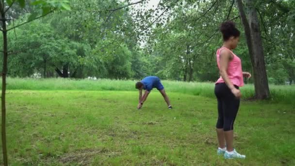 Homem e mulher aquecer antes de correr ao ar livre . — Vídeo de Stock