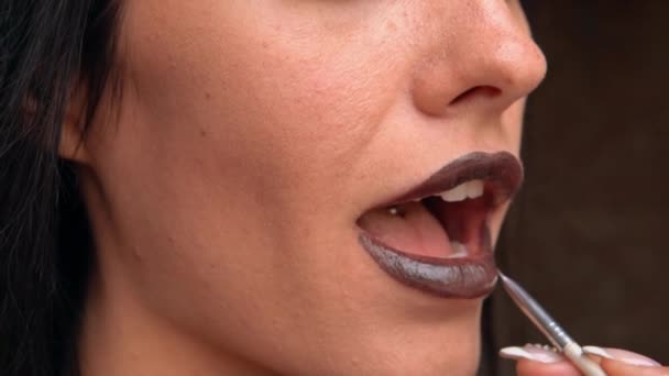 Close up brunette using lipstick — Stock video