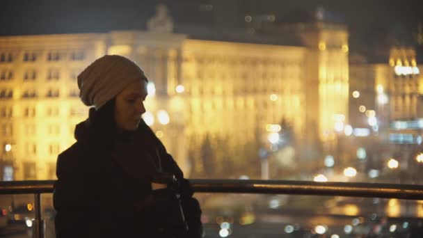 Kadın kahve içme ve telefonda konuşurken akşam sokakta — Stok video