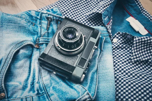 Old camera on jeans — Stock Photo, Image