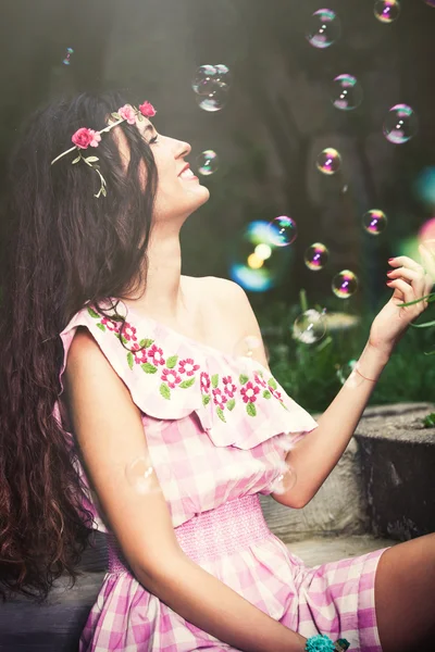 Smiling woman and bubbles — Stock Photo, Image