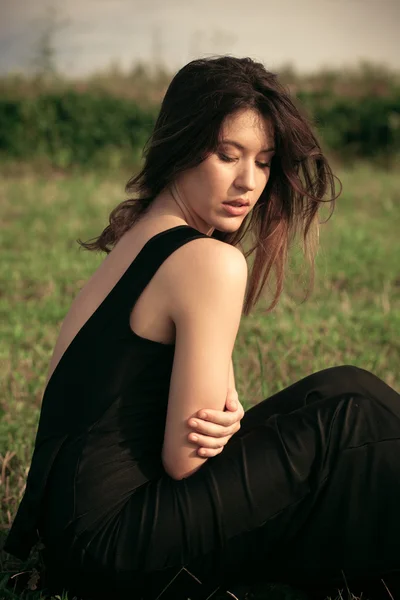 Young woman in black dress — Stock Photo, Image