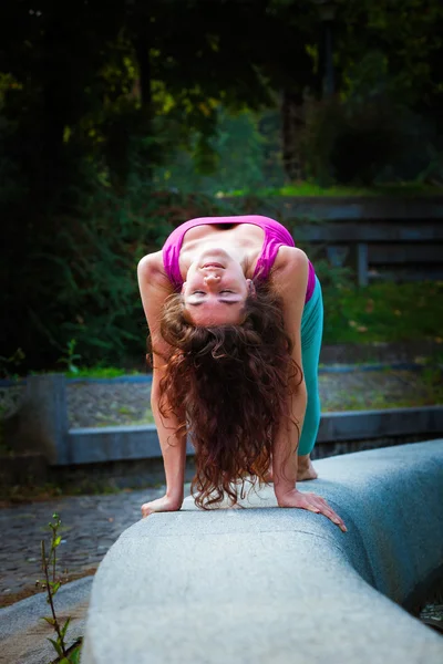 Mujer joven practica yoga al aire libre — Foto de Stock