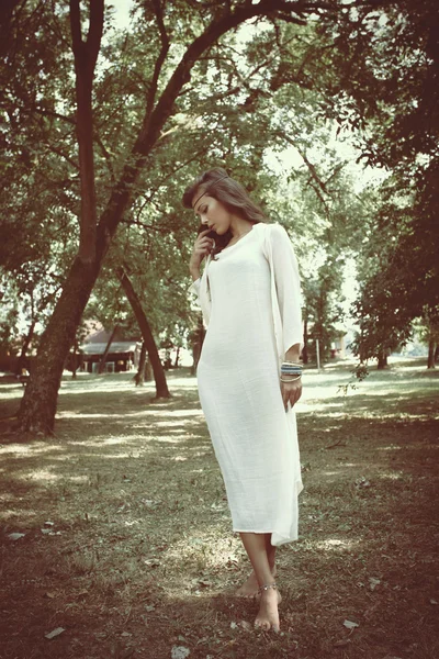 woman standing between trees