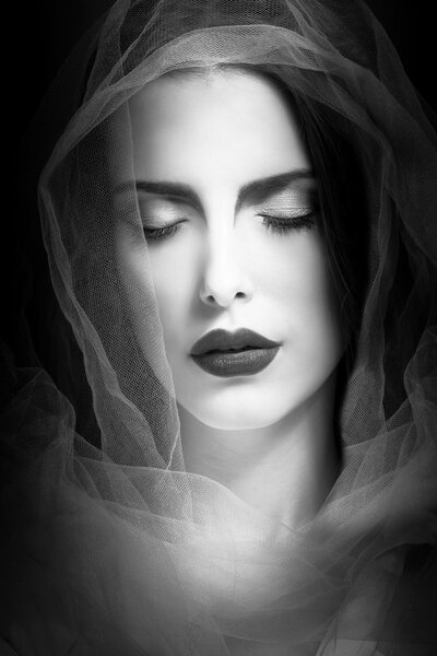Mystical woman beauty portrait with veil, studio shot, closeup, black and white
