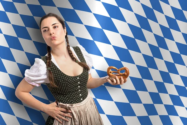 Bavarian Oktoberfest waitress with the Bavarian flag in background — Stock Photo, Image