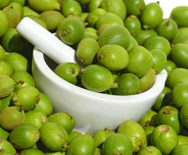 Green young walnuts in husks — Stock Photo, Image