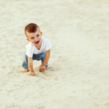 plaj boyunca yürüyen kum, gülen çocuk