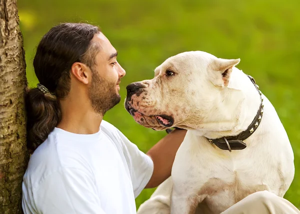 Man and Dog Argentino walk in the park. — Stock Photo, Image
