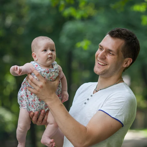 Parents with baby in park — Stock Photo, Image