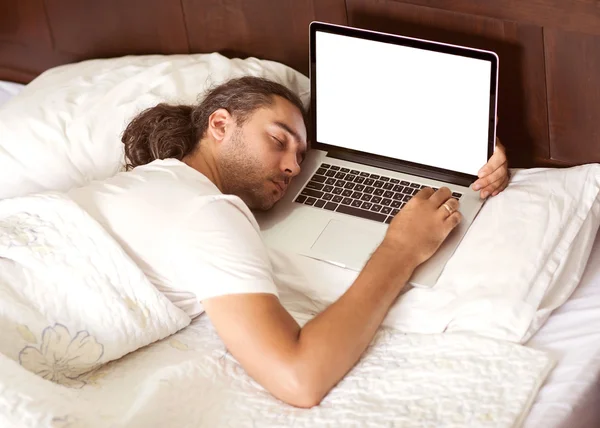 man freelancer lies a sleep in bed with a laptop, work is free e