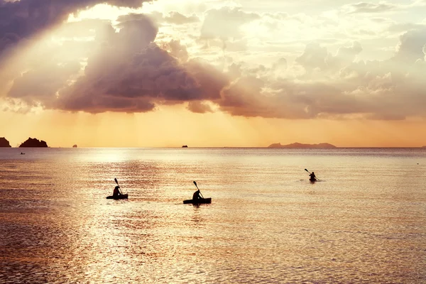 Tres kayak flotan al atardecer — Foto de Stock