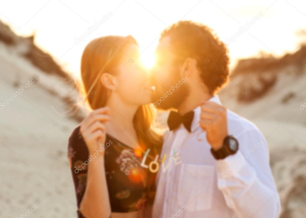 Young couple in love walking in the  park holding hands looking 