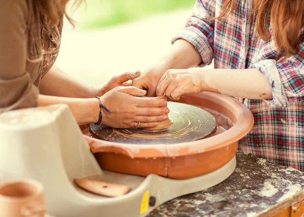 Hands working on pottery wheel — Stock Photo, Image