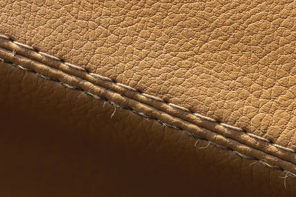Artificial leather car upholstery, color beige, close-up stitching in macro mode — Stock Photo, Image