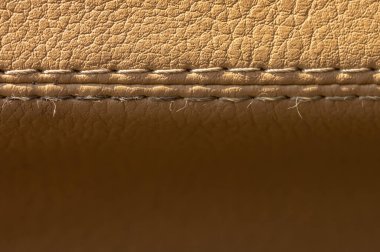 Bej rengi, eski deri kaplama kaplama, dikişli makro. Tekstil otomatik arkaplan