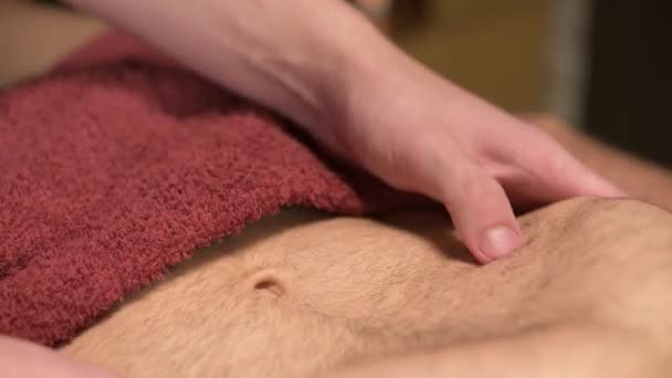 Close-up massage of the diaphragm and placement of organs in the abdominal cavity of a male athlete by a physiotherapist. Alternative medicine — Stock Video