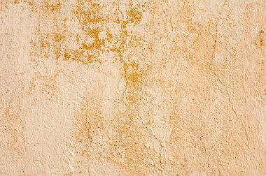 Kırık soyulmuş duvarların arkaplanı ve bej renkte soyulmuş macun.