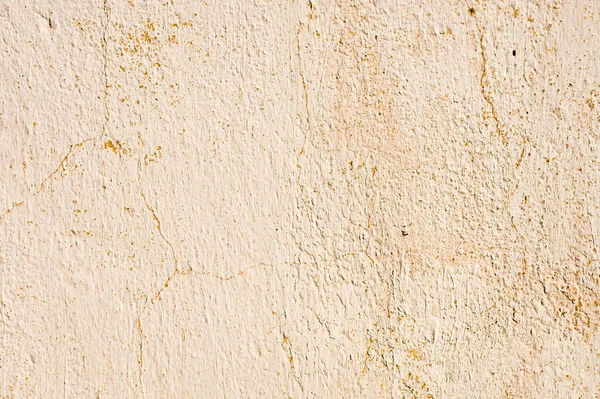 Fondo grunge de paredes peladas agrietadas con masilla pelada en tonos beige — Foto de Stock