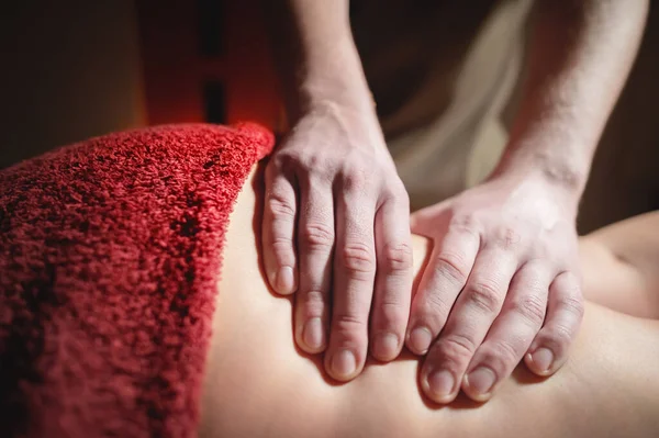 Beauticians hands doing massage for the female leg - close-up — Stock Photo, Image