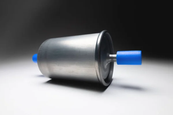 New fuel filter for gasoline internal combustion engine with blue caps on a gray background. New spare parts — Stock Photo, Image