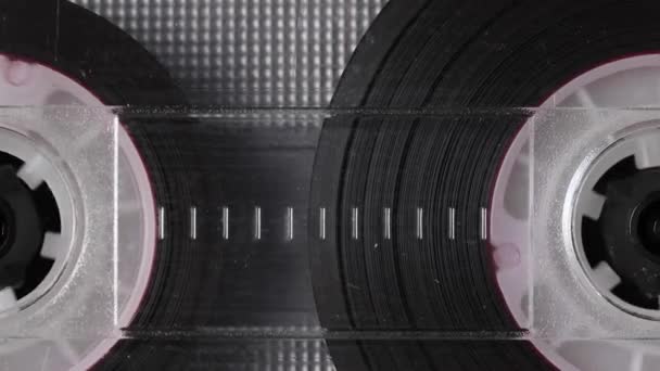 Vintage audio cassette tape playing. Rotation of rolls of film. Close up footage — Stock Video