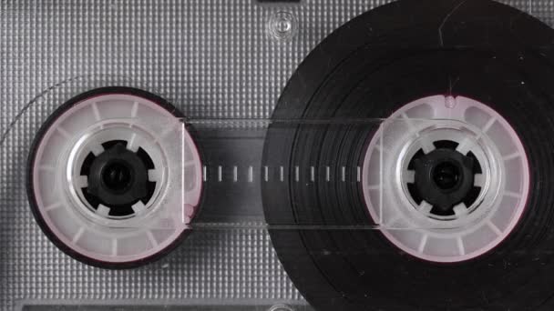 Vintage audio cassette tape playing. Rotation of rolls of film. Close up footage — Stock Video