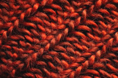 Kırmızı-turuncu örgü arka plan dokusu. Örgü dikişlere yakın çekim. Makro