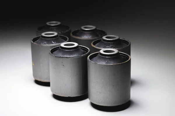 Close-up. A group of cylindrical silent blocks for the rear suspension of an off-road vehicle. Contrast light low key — Stock Photo, Image