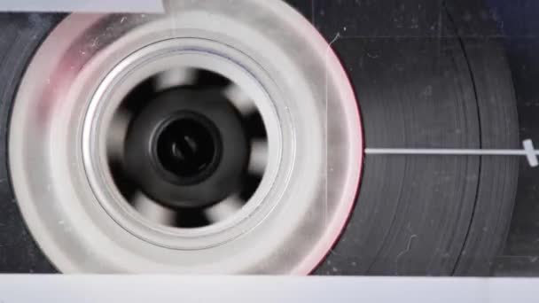 Close-up element of audio cassette. Macro rotation of the reel with audio tape — Stock Video