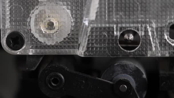 Close-up element of audio cassette. Macro rotation of the reel with audio tape — Stock Video