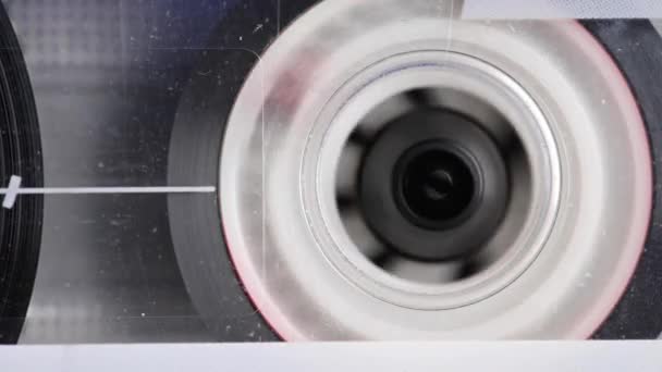 Close-up element of audio cassette. Macro rotation of the reel with audio tape — Stock Video