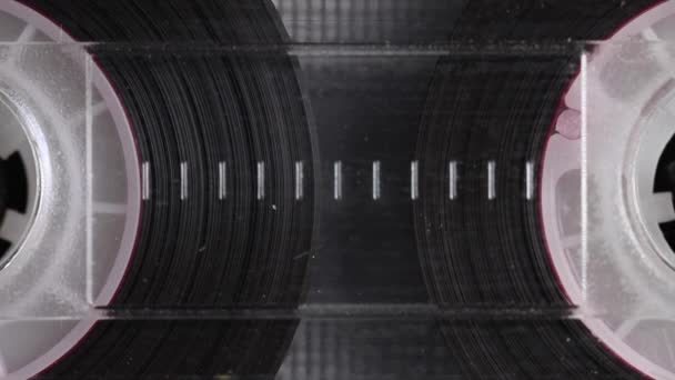 Audio cassette reels tape in extreme close-up. Vintage music cassette played in the player. Close up. — Stock Video