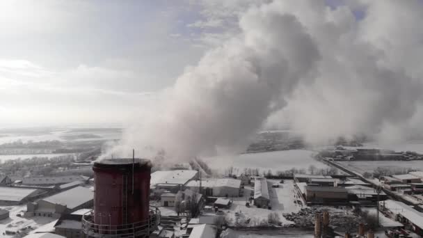 Un tuyau avec des bouffées blanches de fumée. Tuyaux d'une chaufferie à gaz de la ville avec fumée blanche contre le ciel d'hiver. Vue aérienne rapprochée — Video