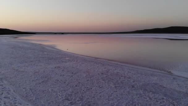 Vista aerea verso il basso inclinato in basso a chiave Pink Salt Lake. Pellicola cinematografica. Sparatoria serale. Sale rosa sano prodotto naturalmente — Video Stock