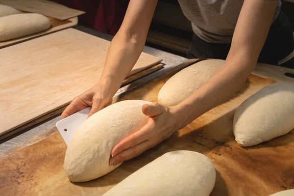 Primer plano de las manos femeninas amasando masa para hacer pan artesanal en la panadería casera —  Fotos de Stock